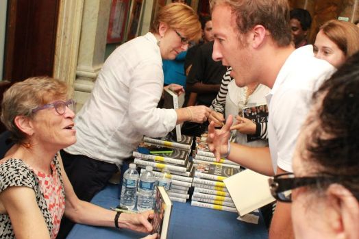 Benedictine volunteer Chris Heitzig gets his book signed.