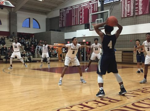 PG Jayden Saddler defends a Pope John guard.