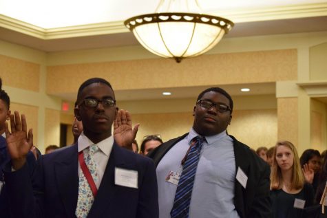 UDII Justin Dickerson (to the left) and Senior Jonathan Lewis (to the right) being sworn into the Youth and Government conference.