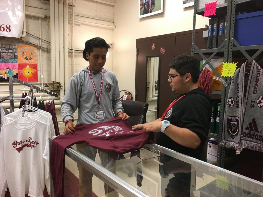 Cashier+and+UDII+Aaron+Sanz+sells+St.+Benedict%27s+merchandise+to+a+customer.